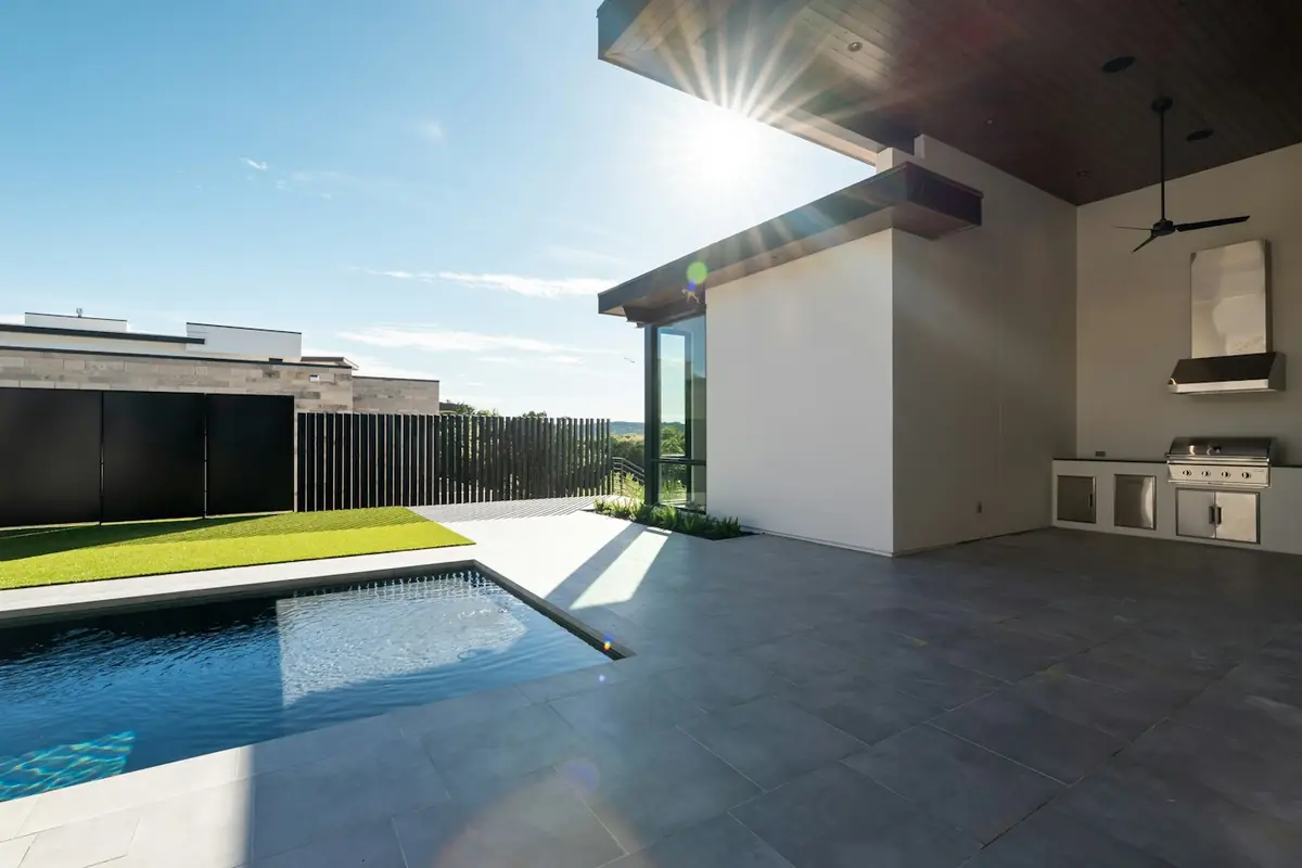 Modern large-format paver patio beside a pool