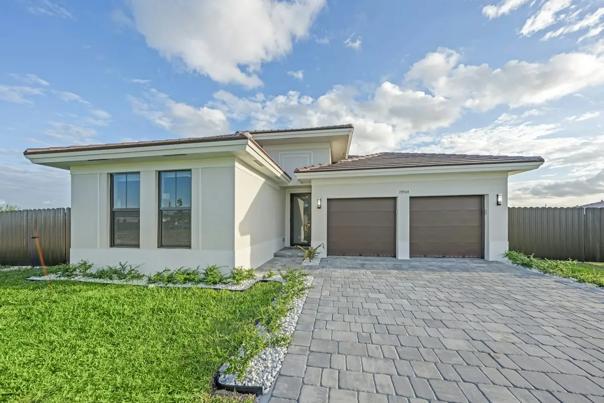 Newly installed grey paver driveway in front of a modern home