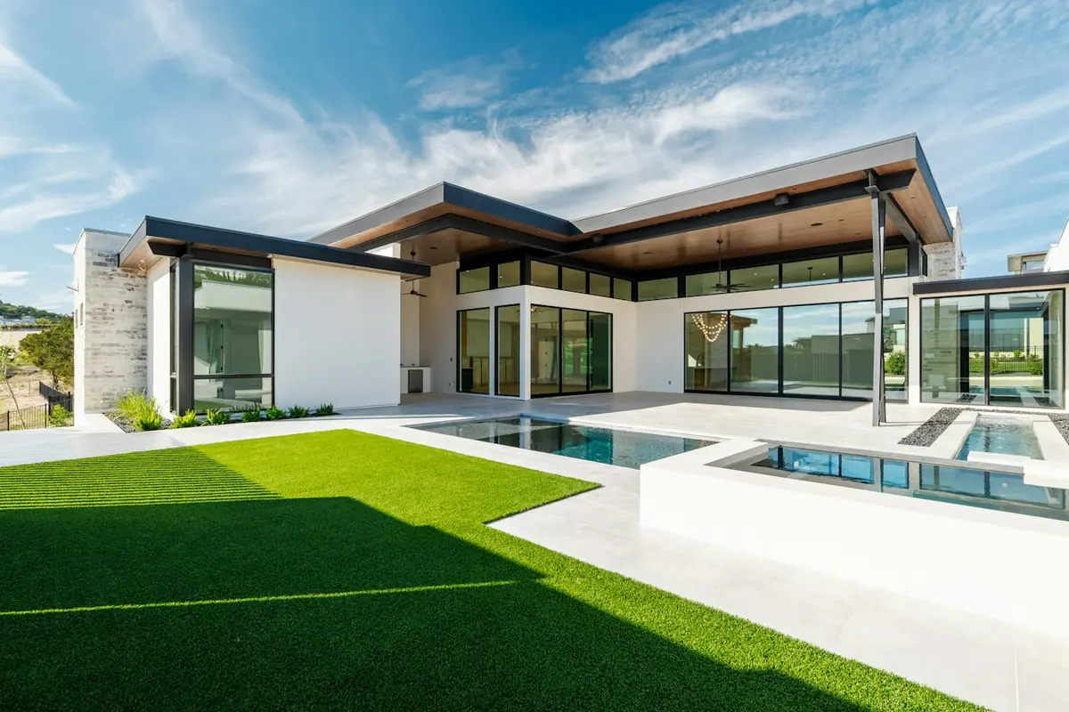Modern backyard with fresh green turf around a pool